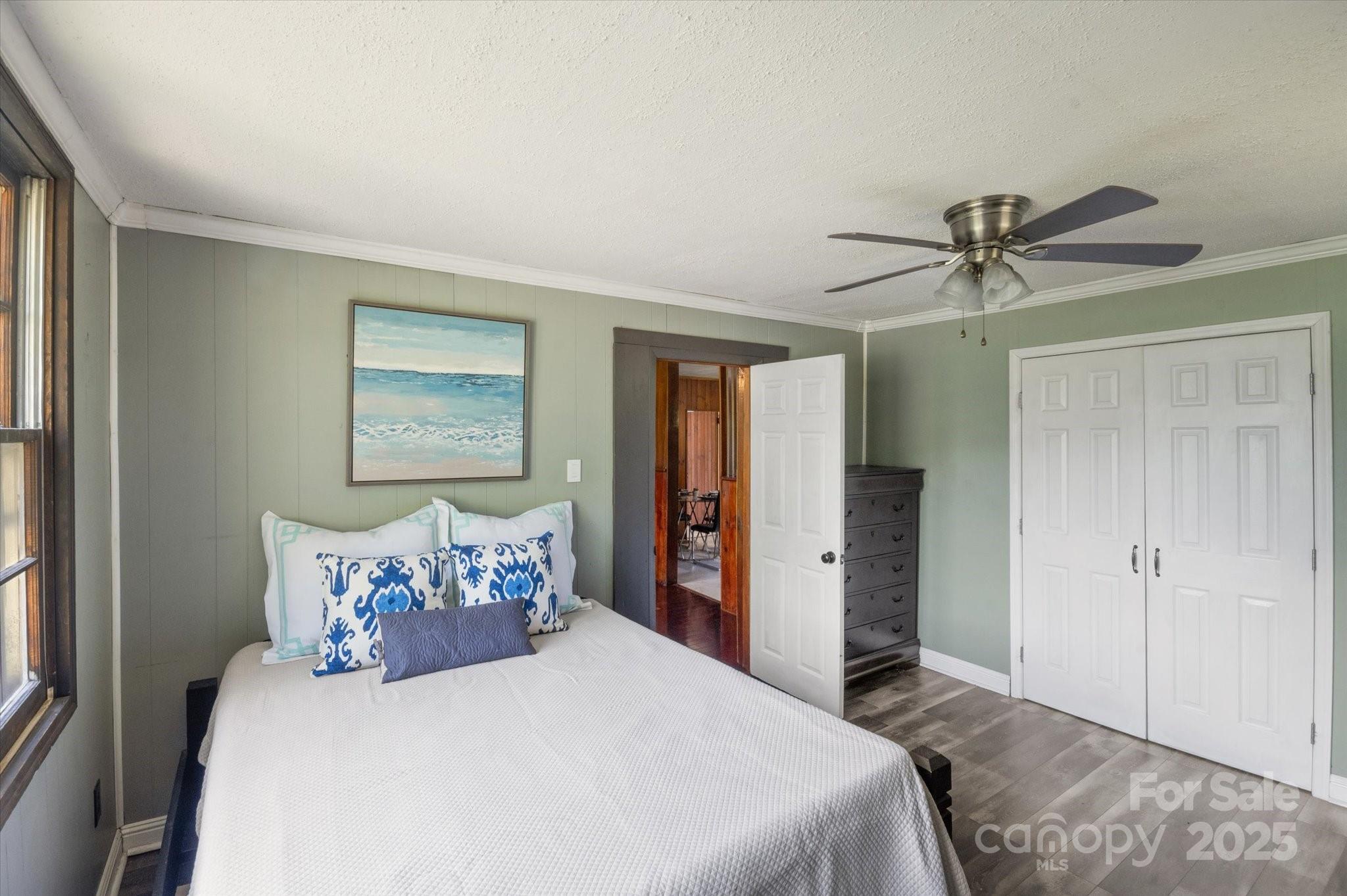 35 Homeway Road Asheville, NC 28806 - Photo 11 of 32 a bedroom with a large bed and a chandelier