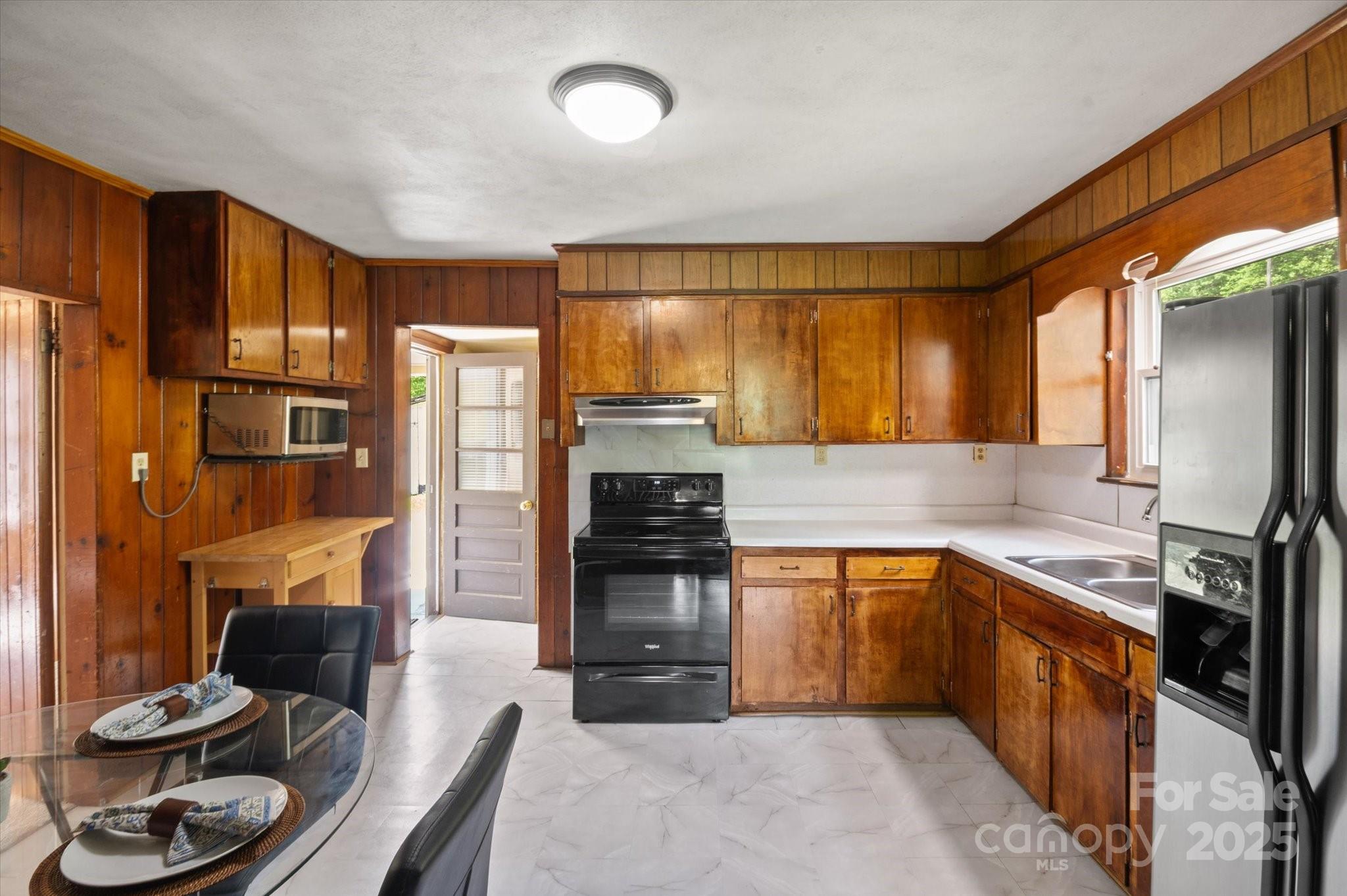 35 Homeway Road Asheville, NC 28806 - Photo 24 of 32 a kitchen with stainless steel appliances granite countertop a refrigerator a stove and a sink with wooden floor