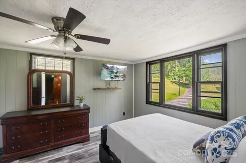 a bedroom with a large bed and a window