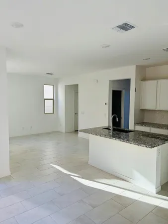 a kitchen with a stove a sink and a microwave