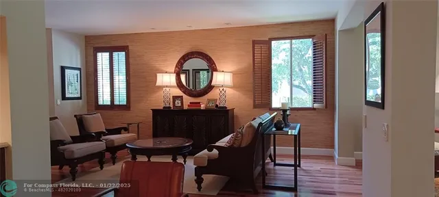 a living room with furniture a window and a fireplace