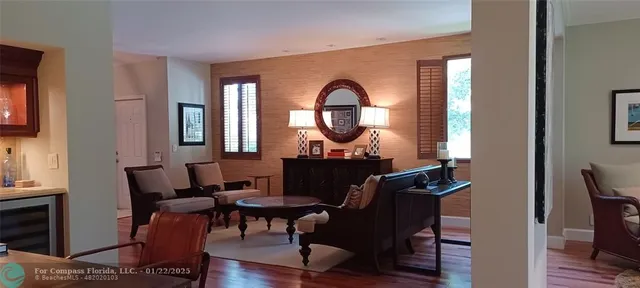 a living room with furniture a mirror and a window