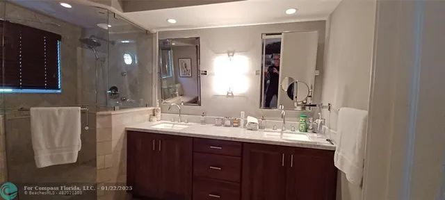 a bathroom with a double vanity sink and a mirror