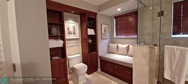 a bathroom with a toilet mirror shower vanity and a sink