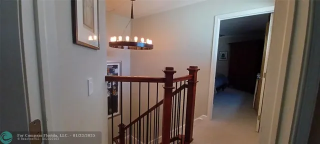 a view of a hallway with a chandelier