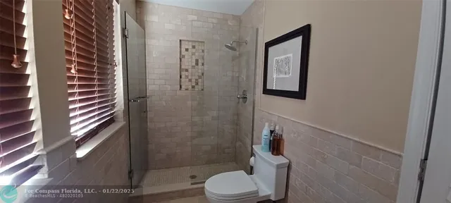 a bathroom with a toilet and shower