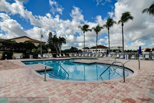 a view of swimming pool with outdoor seating