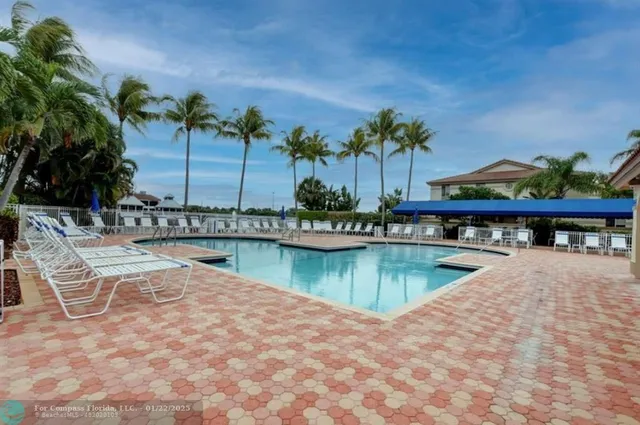 a swimming pool with outdoor seating and yard
