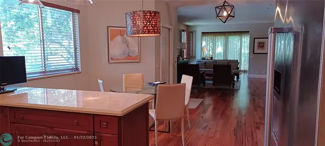 a view of a dining room with furniture and window
