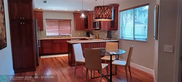 a dining room with furniture and window