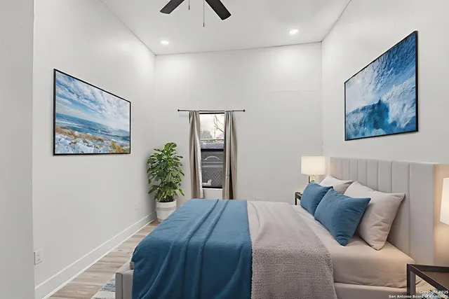 a bedroom with a large bed and a chandelier