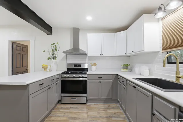 a kitchen with a sink stove and cabinets