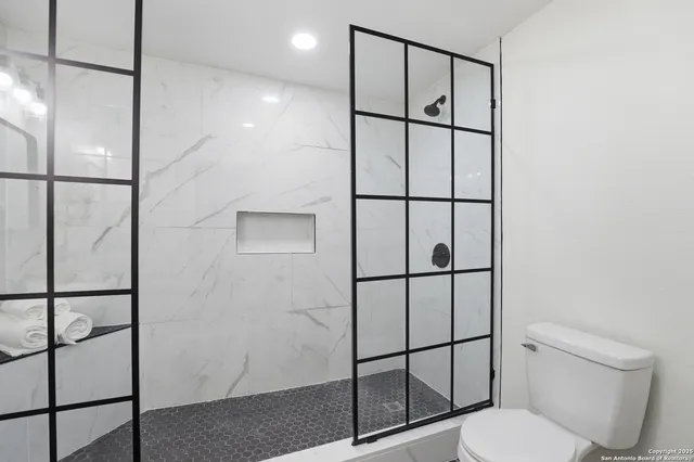 a bathroom with a shower toilet and sink