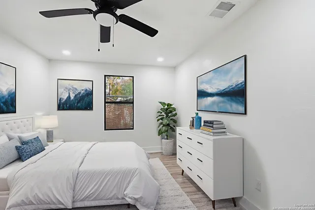 a bedroom with a large bed and a flat screen tv