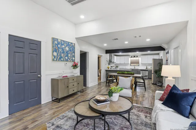 a living room with furniture and kitchen view