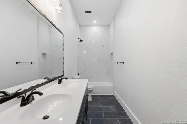 a bathroom with a sink and a mirror