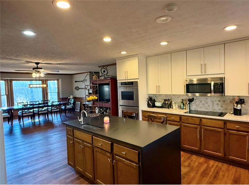 4570 Settles Bridge Road Suwanee, GA 30024 - Photo 3 of 21 a kitchen with lots of counter top space and dining table