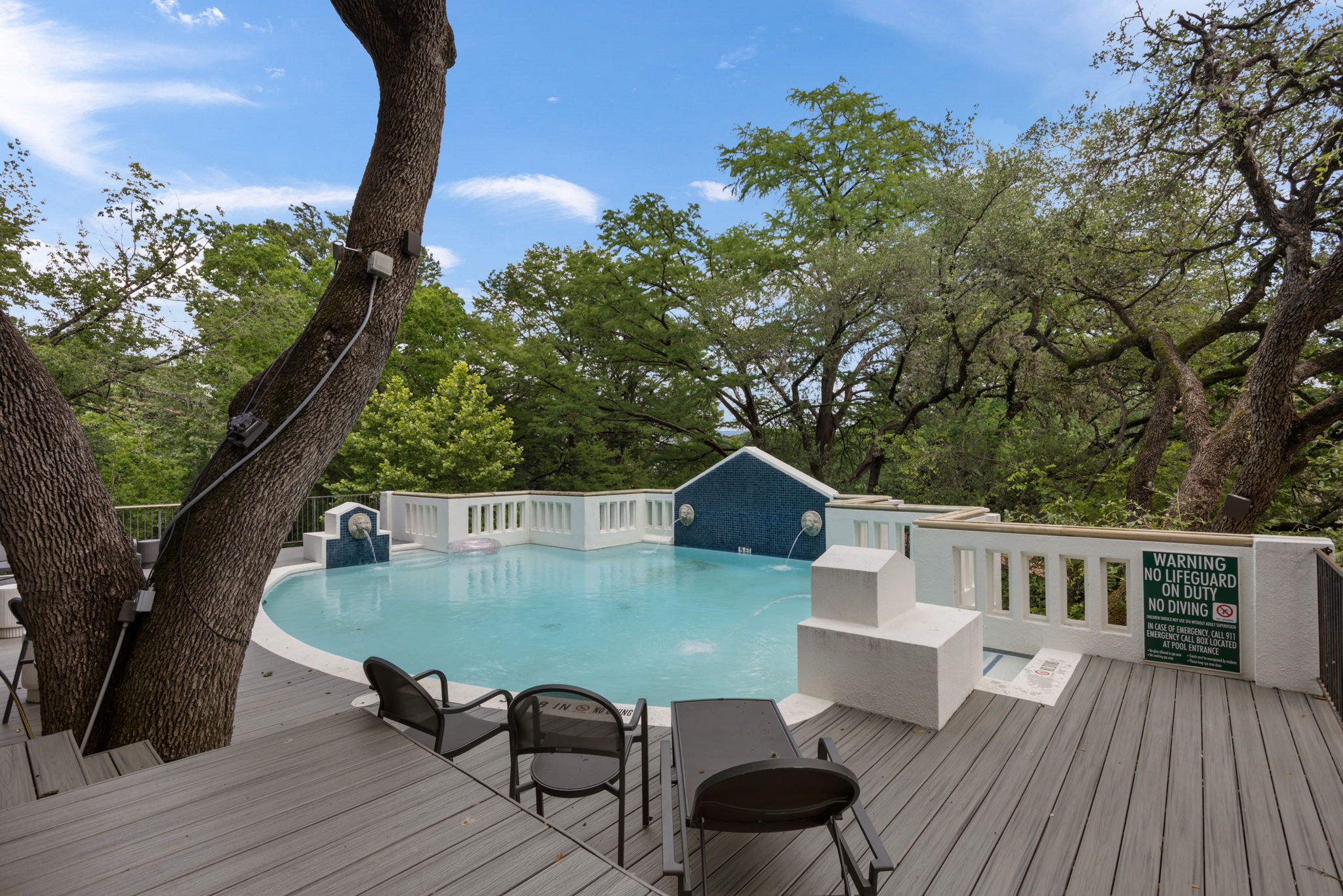 1910 Rue De St Tropez, Unit 6 Austin, TX 78746 - Photo 31 of 37 An inviting pool, complete with water features, is perfectly integrated into the expansive outdoor deck.