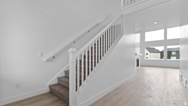 4170 North 560th West, Unit 6 Tooele, UT 84074 - Photo 7 of 20 Carpeted staircase with white balusters and handrail