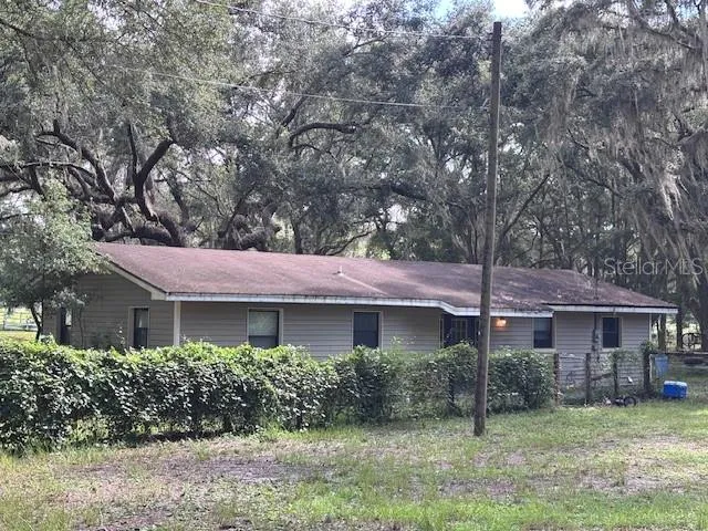 a kitchen with stainless steel appliances granite countertop a refrigerator a sink and wooden cabinets