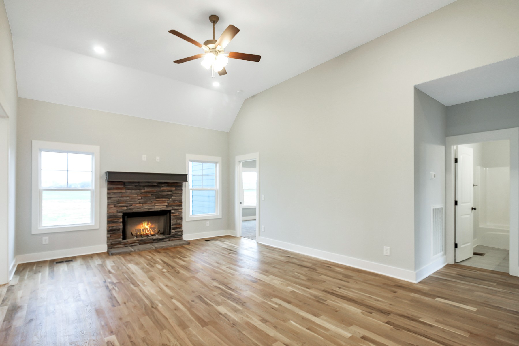 4889 Barren Plains Road Springfield, TN 37172 - Photo 3 of 17 an empty room with wooden floor fireplace and window