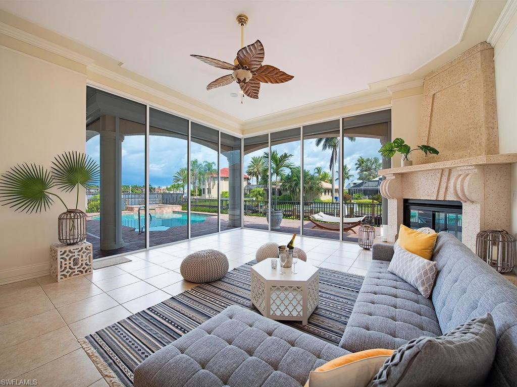 1860 Kingfish Road Naples, FL 34102 - Photo 4 of 24 Family Room with Fireplace. Gorgeous views of pool/lanai area, with the deep canal and Naples Bay.
