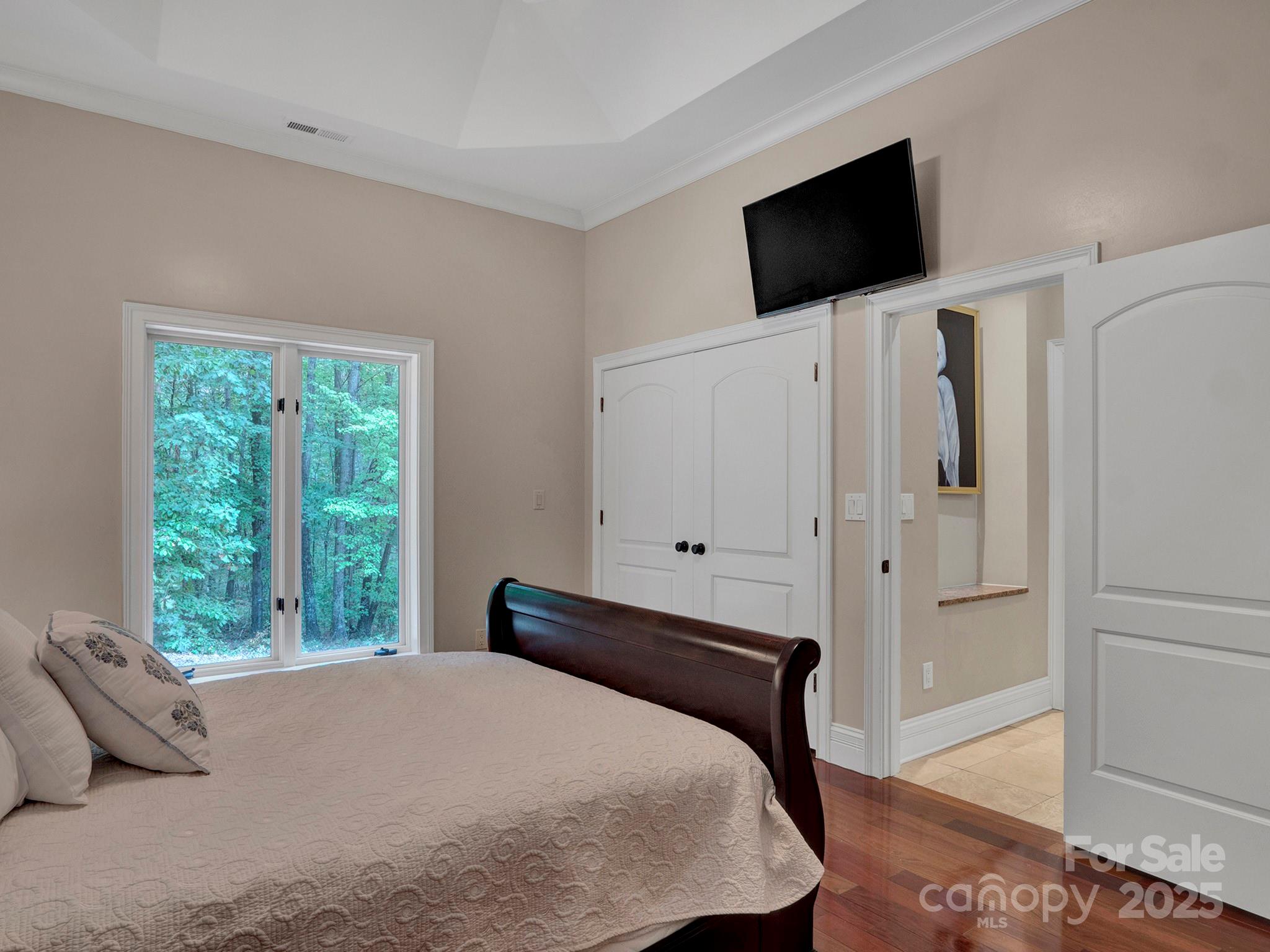225 Riverton Road Weddington, NC 28104 - Photo 20 of 41 a bedroom with a bed a flat screen tv and a window