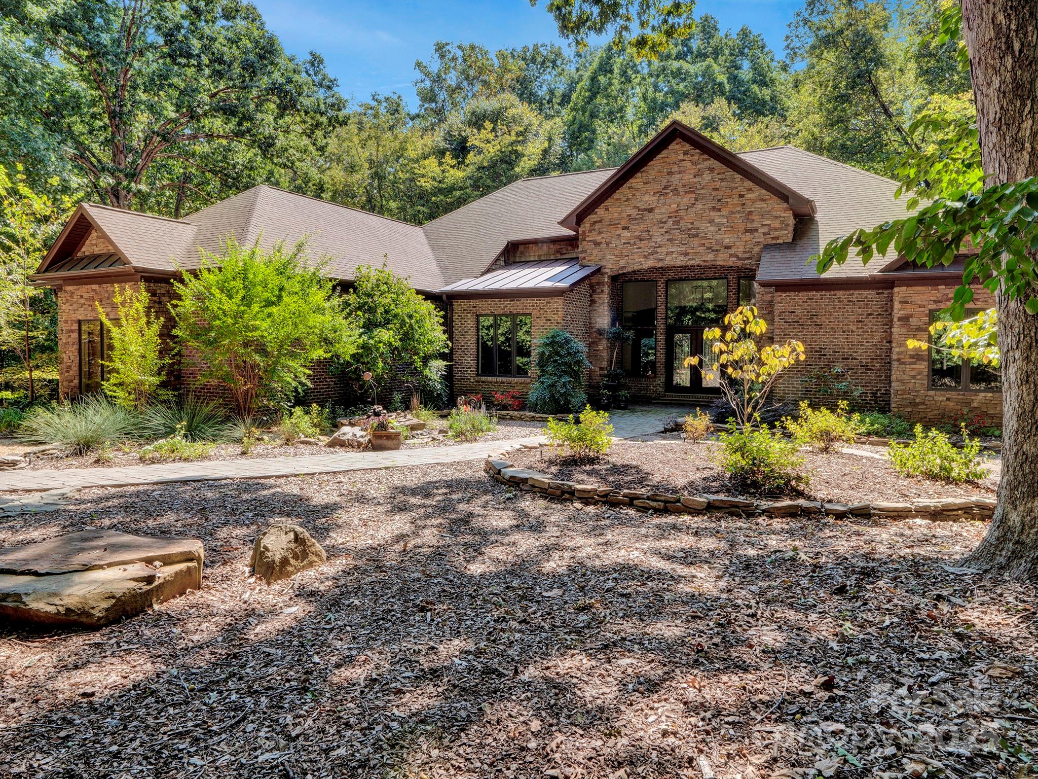 225 Riverton Road Weddington, NC 28104 - Photo 2 of 41 a front view of a house with garden