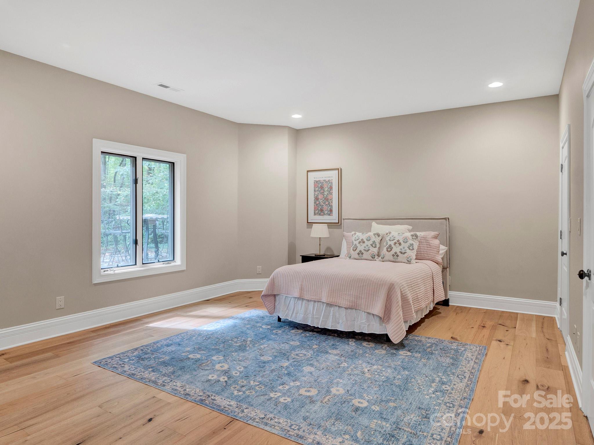 225 Riverton Road Weddington, NC 28104 - Photo 33 of 41 a spacious bedroom with a bed and a window