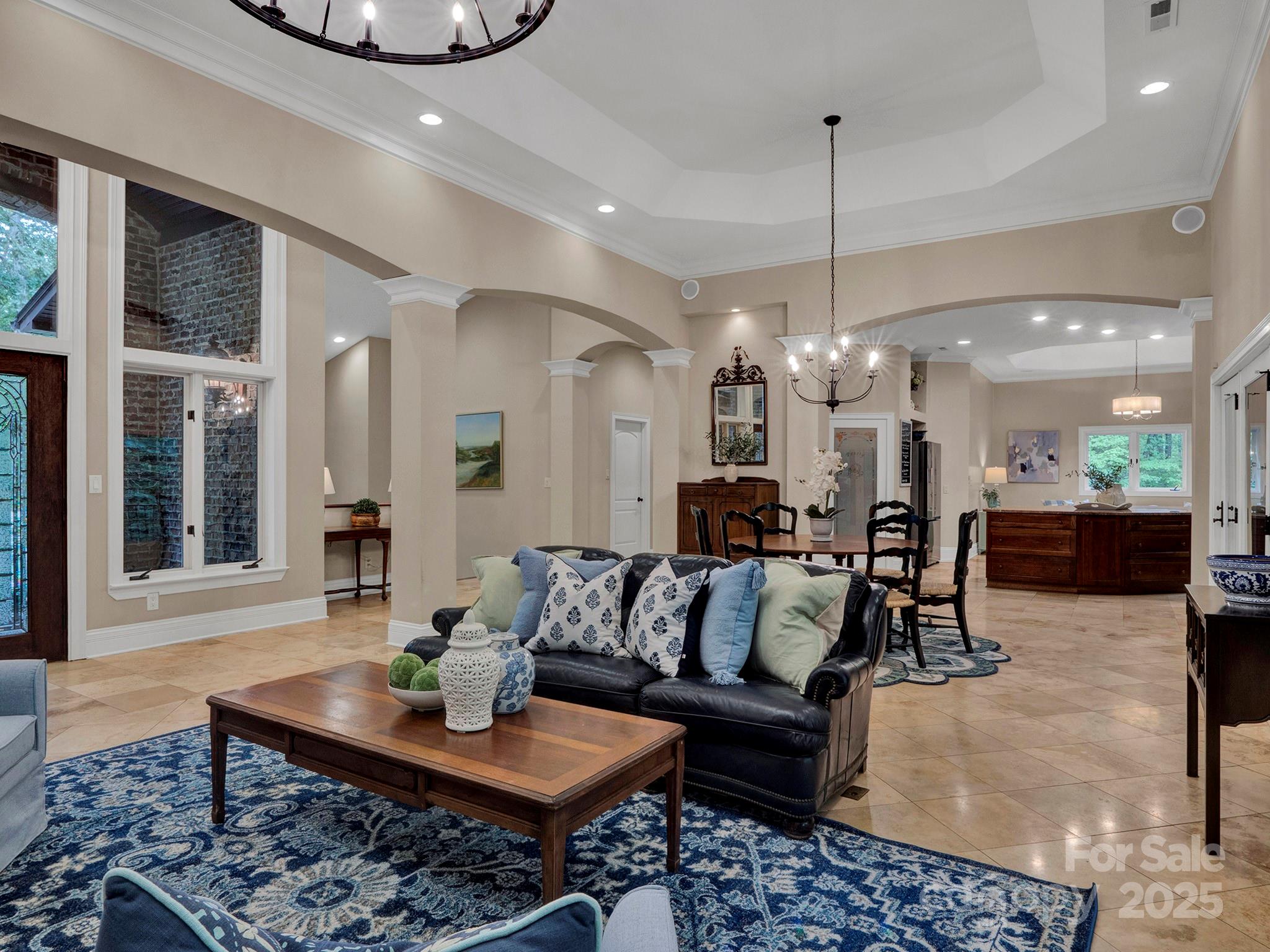 225 Riverton Road Weddington, NC 28104 - Photo 6 of 41 a living room with furniture and a chandelier