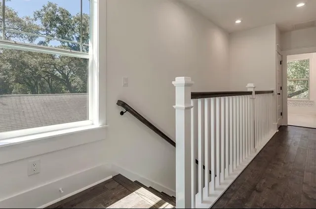 a view of a hallway with a wooden floor