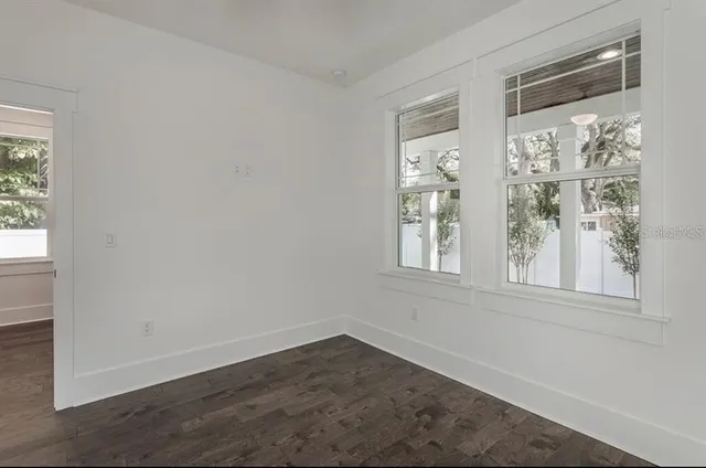 an empty room with wooden floor