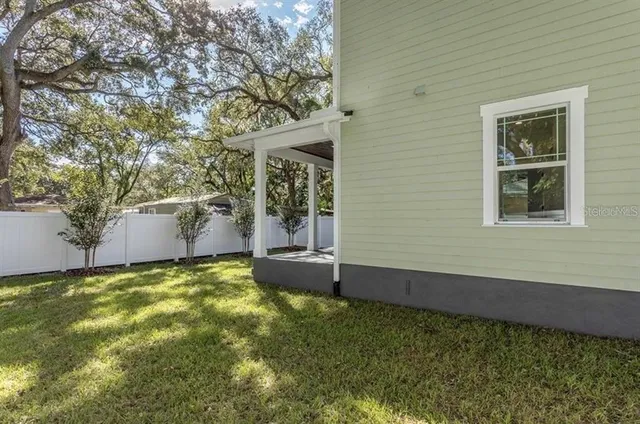 a view of a house with a yard and sitting area