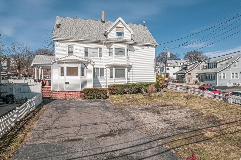 12 Jones Avenue, Unit 1 Chelsea, MA 02150 - Photo 16 of 17 a view of a white house with large windows next to a road