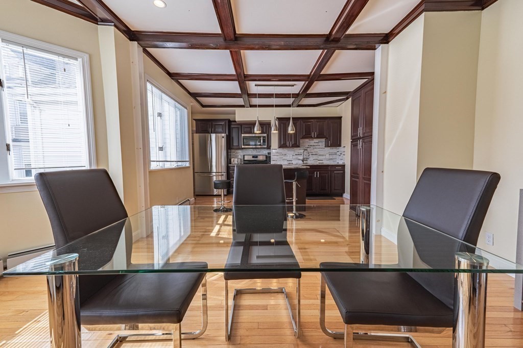 12 Jones Avenue, Unit 1 Chelsea, MA 02150 - Photo 4 of 17 a view of a dining room with furniture and wooden floor