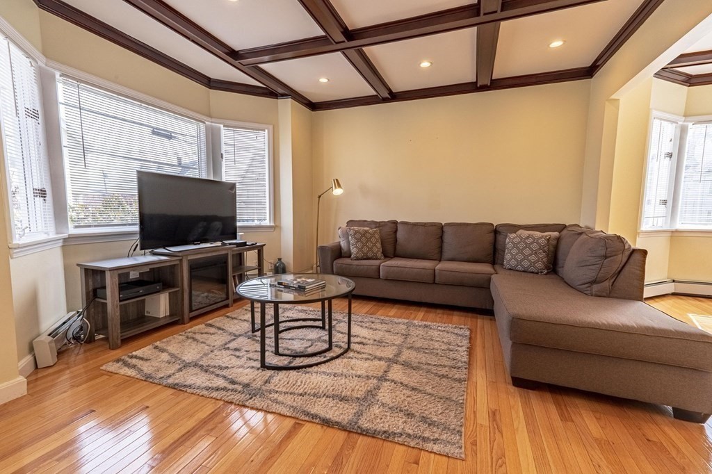 12 Jones Avenue, Unit 1 Chelsea, MA 02150 - Photo 6 of 17 a living room with furniture and a flat screen tv