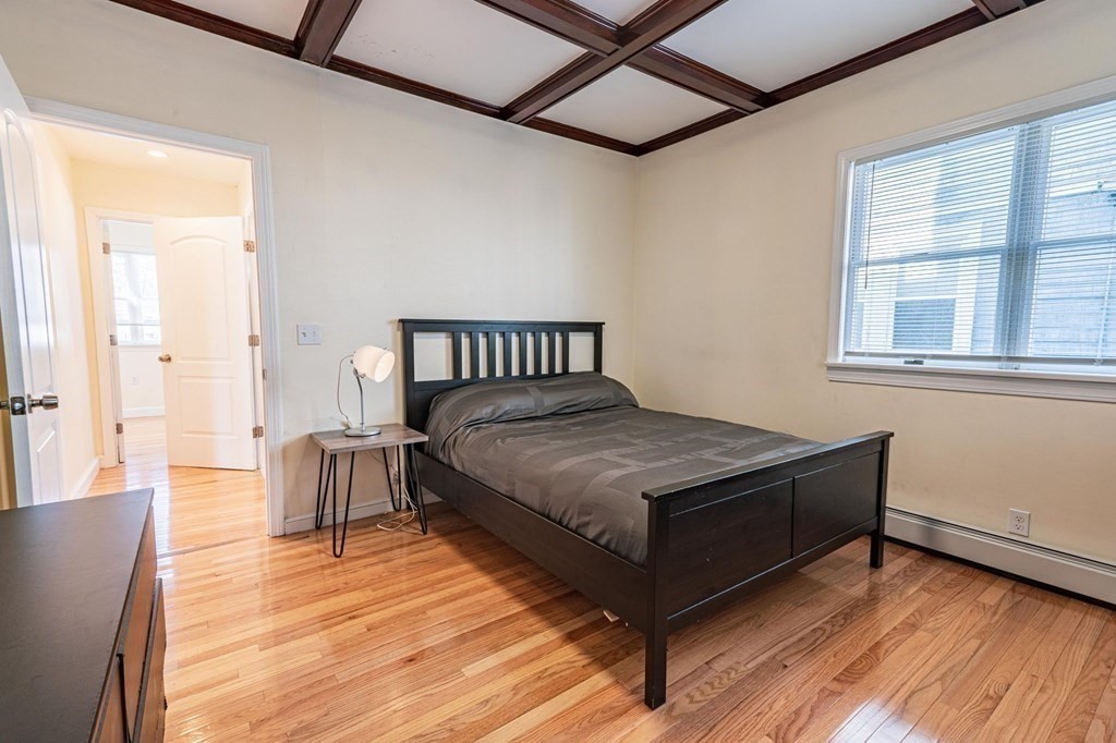 12 Jones Avenue, Unit 1 Chelsea, MA 02150 - Photo 9 of 17 a bed sitting in a bedroom next to a window