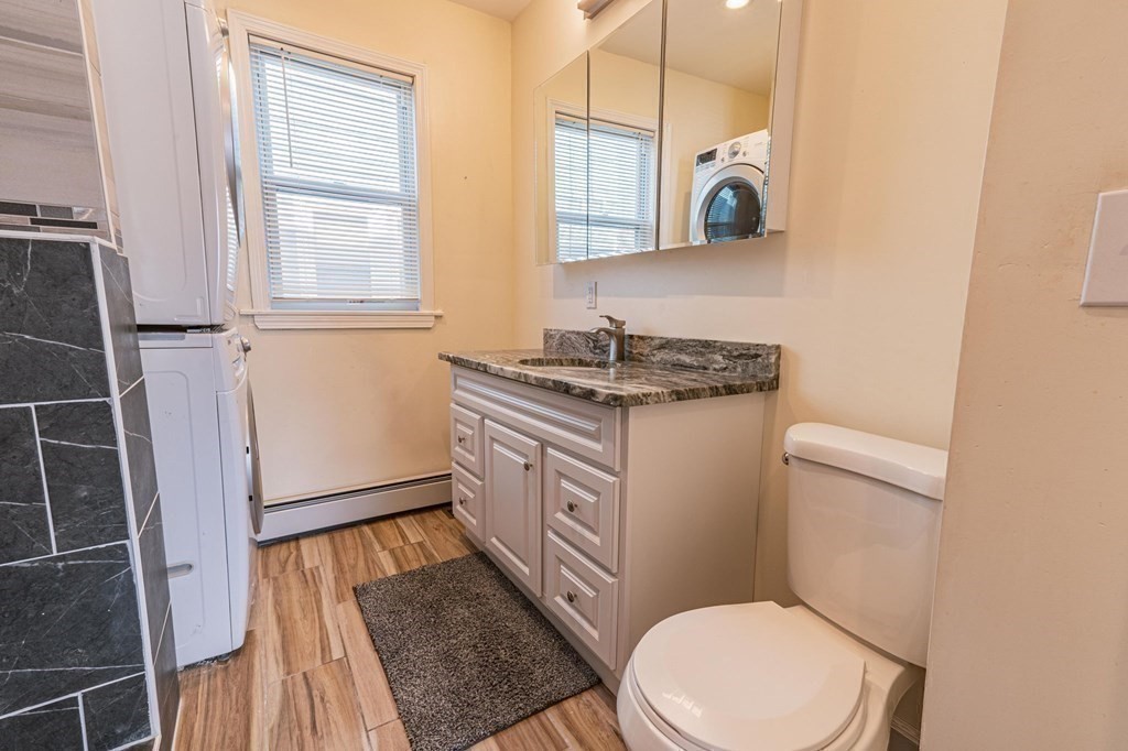 12 Jones Avenue, Unit 1 Chelsea, MA 02150 - Photo 10 of 17 a bathroom with a granite countertop toilet sink and mirror