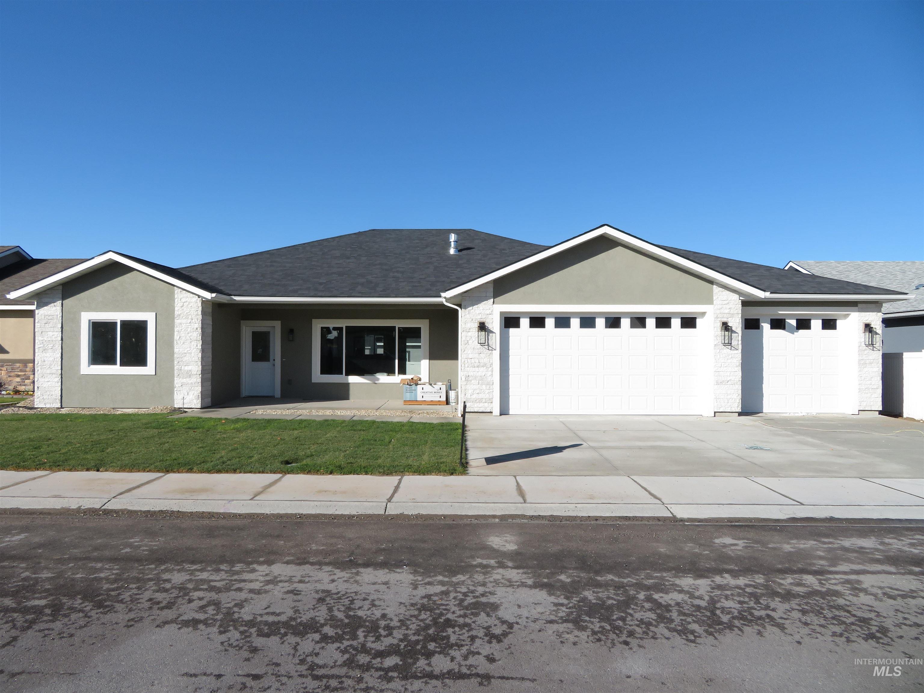 Ranch-style house featuring a porch, stucco siding, concrete driveway, roof with shingles, and an attached garage