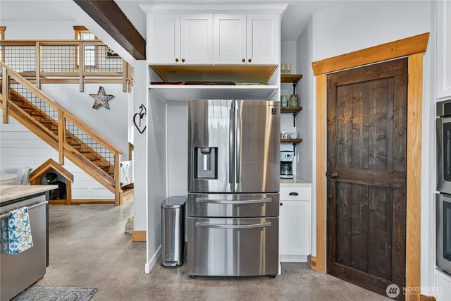 a open kitchen with a stove and a chandelier