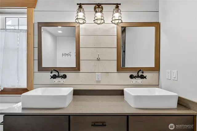 a bathroom with a tub sink and mirror