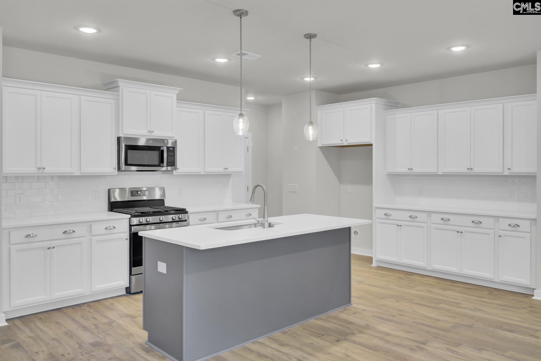 320 Brass Billion Path Lexington, SC 29073 - Photo 13 of 39 a kitchen with a sink a stove a refrigerator and white cabinets
