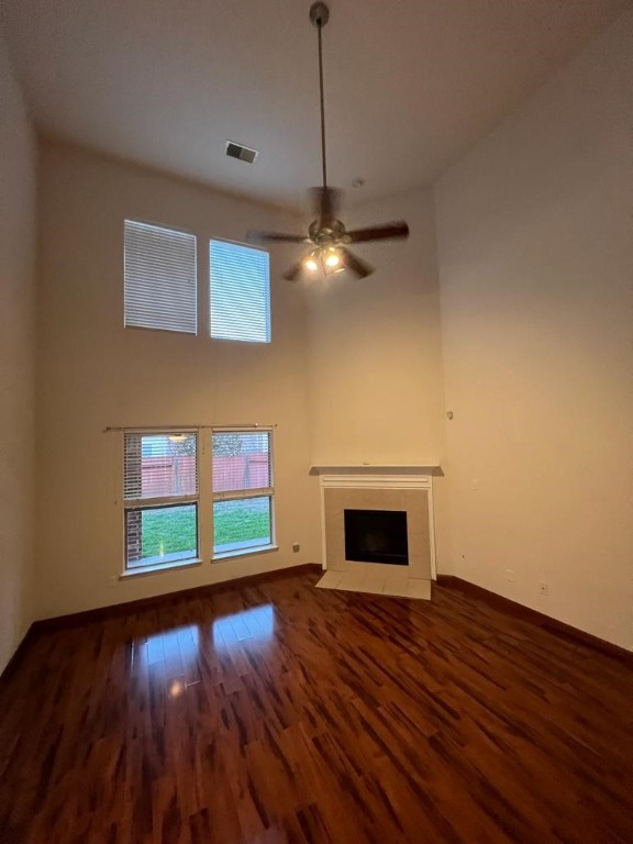 411 Stream Mill Lane Katy, TX 77494 - Photo 16 of 29 a view of an empty room with wooden floor fireplace and a window