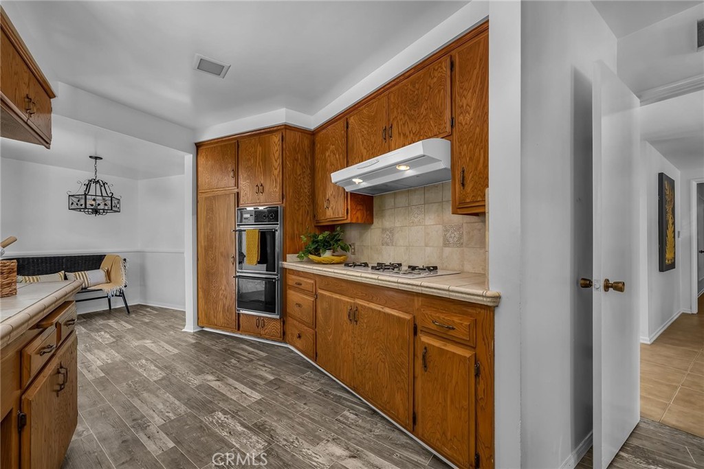 5203 Middlecrest Road Rancho Palos Verdes, CA 90275 - Photo 11 of 28 a kitchen with stainless steel appliances a stove refrigerator sink and cabinets