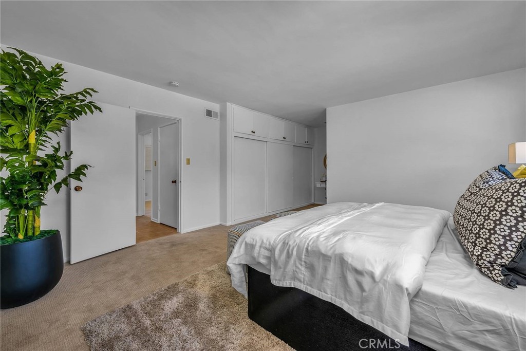 5203 Middlecrest Road Rancho Palos Verdes, CA 90275 - Photo 23 of 28 a bedroom with a bed and a potted plant
