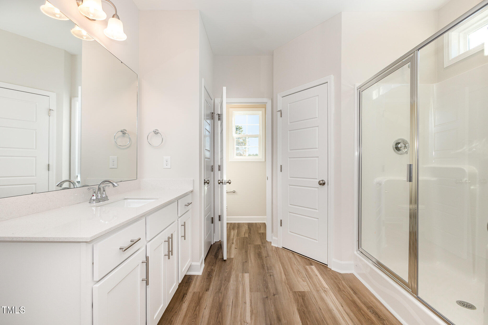 15 Barony Lane Smithfield, NC 27577 - Photo 18 of 24 a bathroom with a sink a mirror a vanity and a shower
