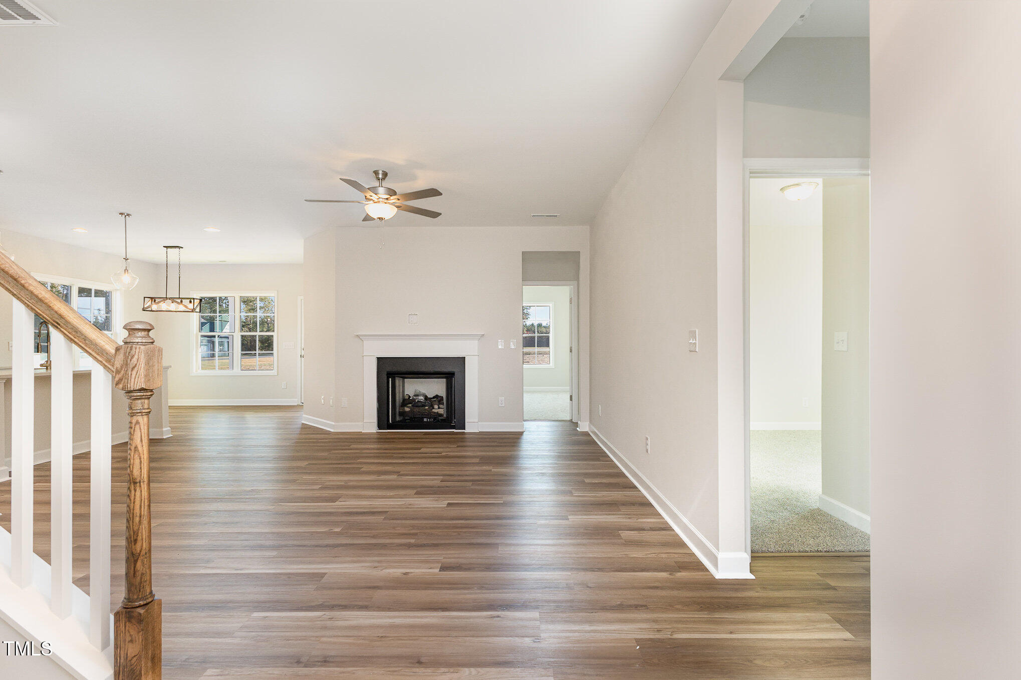 15 Barony Lane Smithfield, NC 27577 - Photo 5 of 24 a view of an empty room with wooden floor and a fireplace