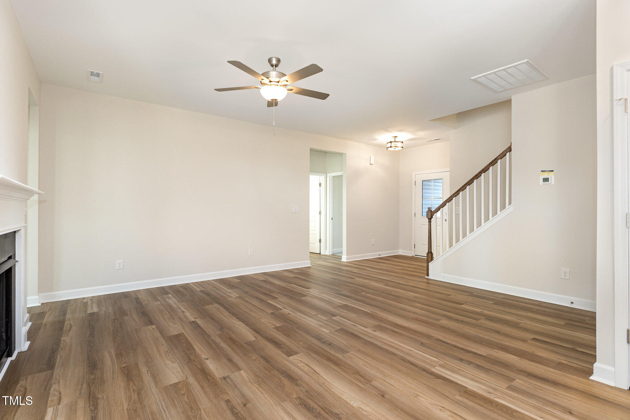 15 Barony Lane Smithfield, NC 27577 - Photo 7 of 24 a view of an empty room with wooden floor and a fan