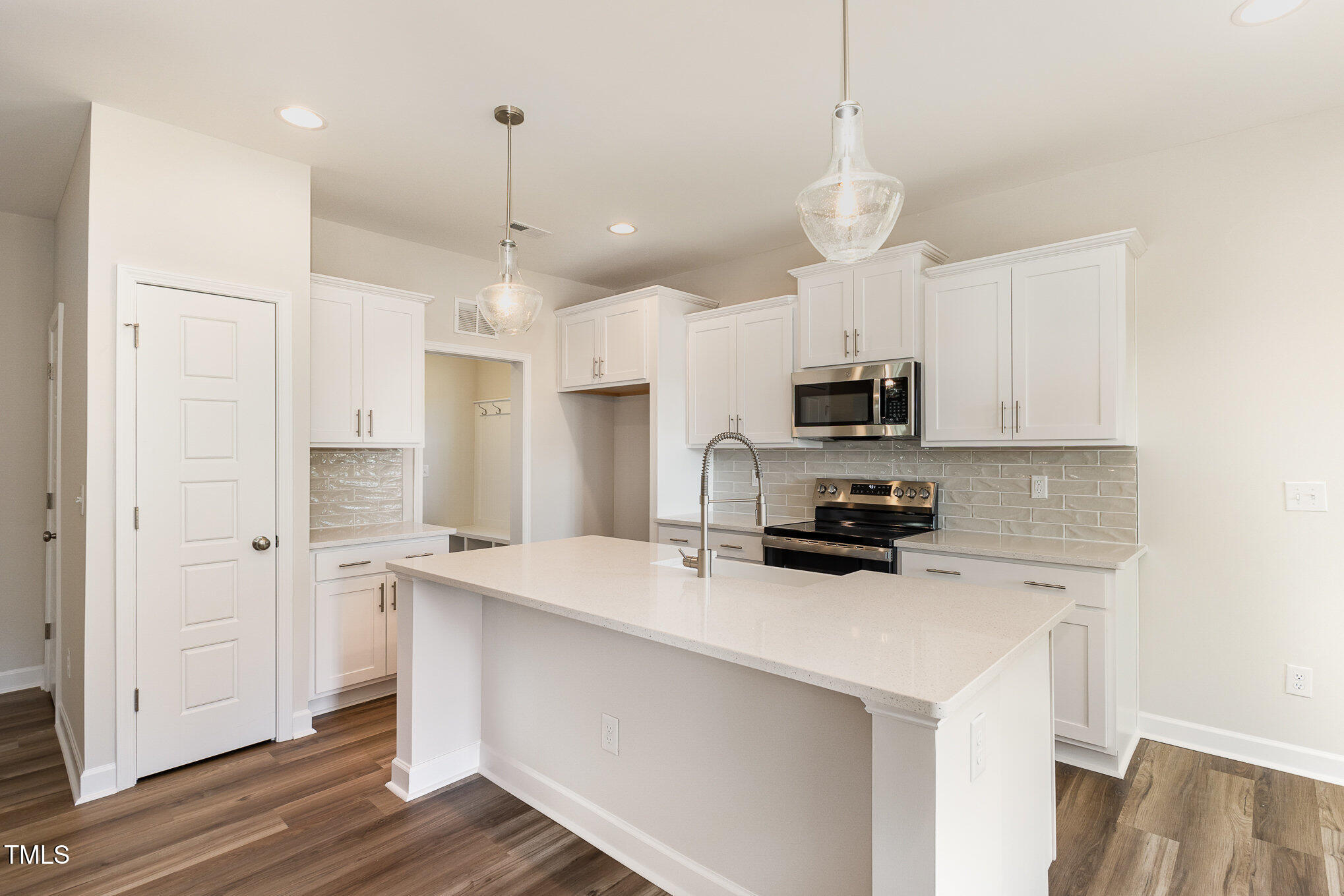 15 Barony Lane Smithfield, NC 27577 - Photo 10 of 24 a kitchen with kitchen island a sink stainless steel appliances and cabinets