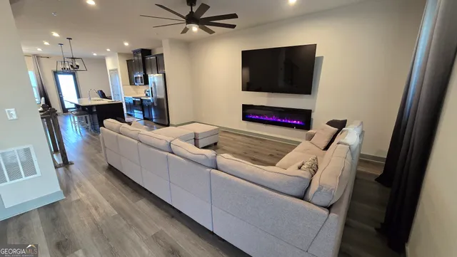 a living room with furniture and a flat screen tv